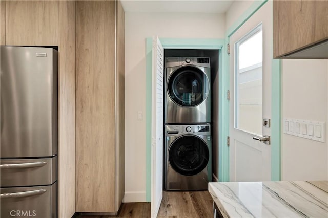 225 S Guadalupe Ave, Redondo Beach, CA 90277 - laundry room featuring stacked washer / dryer, wood finished floors, and baseboards