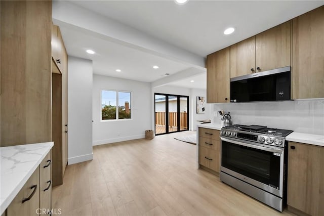 3241 Dalemead St, Torrance, CA 90505 - kitchen featuring stainless steel gas range, baseboards, light stone counters, light wood finished floors, and recessed lighting