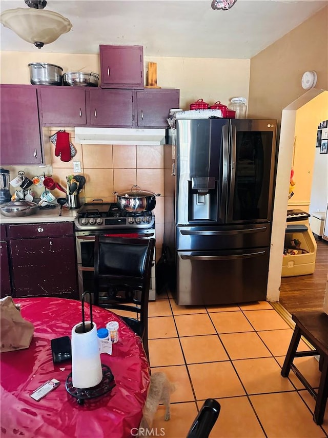 1196 N Hamilton Blvd, Pomona, CA 91768 - kitchen with stainless steel fridge with ice dispenser, range with gas cooktop, under cabinet range hood, and light tile patterned floors