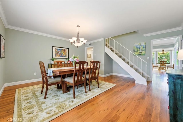 17152 Friml Ln, Huntington Beach, CA 92649 - dining room featuring stairway, a chandelier, wood finished floors, ornamental molding, and baseboards