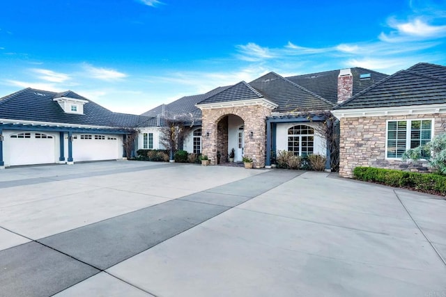 3401 Adams Run, Encinitas, CA 92024 - french country home with stone siding, a garage, and concrete driveway