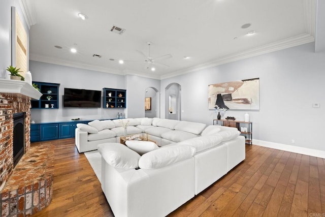 3401 Adams Run, Encinitas, CA 92024 - living room featuring wood-type flooring, a brick fireplace, a ceiling fan, recessed lighting, and arched walkways