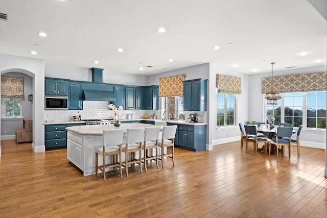 3401 Adams Run, Encinitas, CA 92024 - kitchen with blue cabinetry, built in microwave, light countertops, baseboards, and recessed lighting