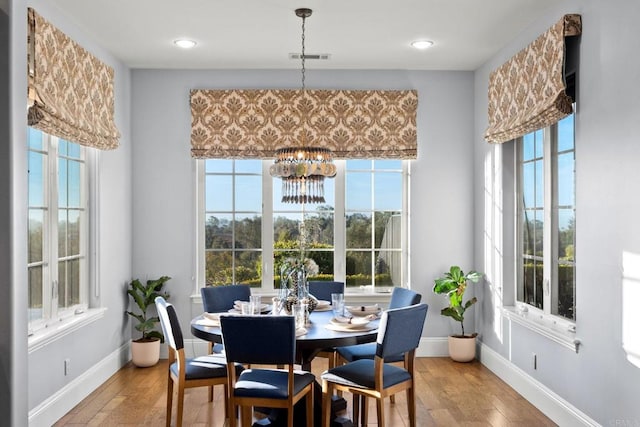 3401 Adams Run, Encinitas, CA 92024 - dining room featuring a chandelier, plenty of natural light, and hardwood / wood-style floors