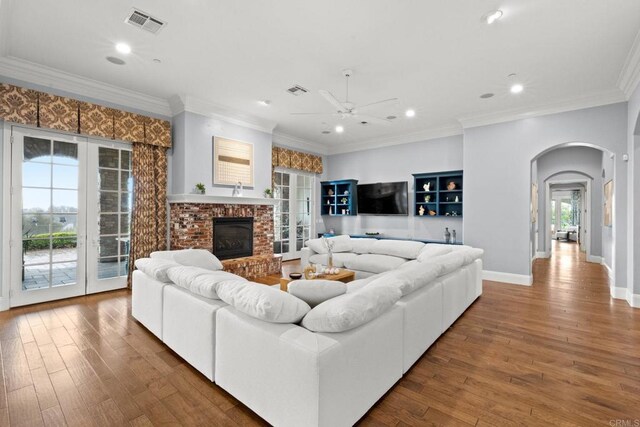 3401 Adams Run, Encinitas, CA 92024 - living area with arched walkways, a ceiling fan, hardwood / wood-style floors, recessed lighting, and a brick fireplace