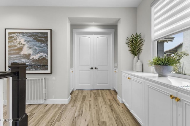 4173 Caribbean St, Oxnard, CA 93035 - corridor featuring light wood-type flooring, baseboards, and radiator