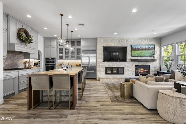 4173 Caribbean St, Oxnard, CA 93035 - living room featuring a fireplace, recessed lighting, and wood finished floors