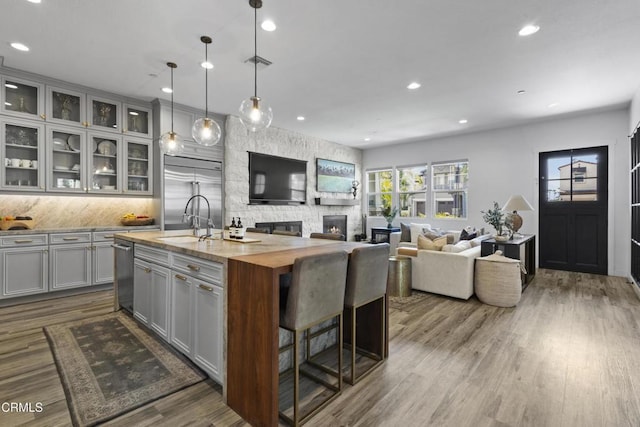 4173 Caribbean St, Oxnard, CA 93035 - kitchen with gray cabinetry, appliances with stainless steel finishes, a sink, a kitchen island with sink, and recessed lighting
