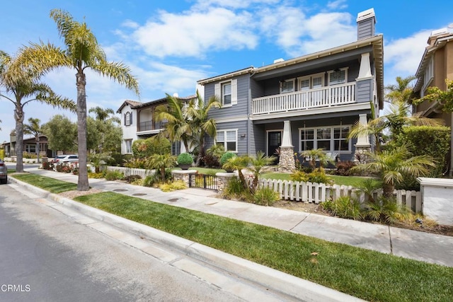 4173 Caribbean St, Oxnard, CA 93035 - view of front of home with a balcony, a fenced front yard, and a chimney