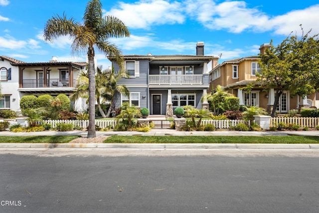 4173 Caribbean St, Oxnard, CA 93035 - view of front of home with a balcony, a fenced front yard, and a chimney