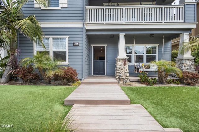 4173 Caribbean St, Oxnard, CA 93035 - view of exterior entry featuring a balcony, covered porch, and a lawn