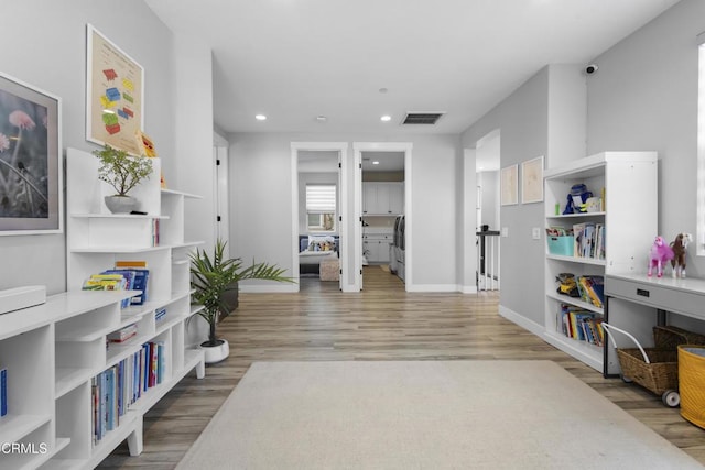 4173 Caribbean St, Oxnard, CA 93035 - sitting room with wood finished floors, washer / clothes dryer, recessed lighting, and baseboards