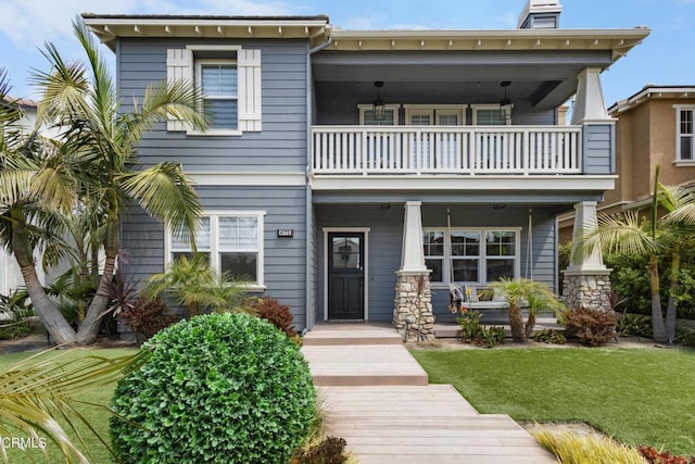 4173 Caribbean St, Oxnard, CA 93035 - view of front of home with a balcony, a porch, a front lawn, and a chimney