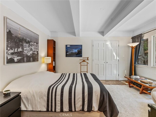 3818 Hollyline Ave, Sherman Oaks, CA 91423 - bedroom with beamed ceiling, wood finished floors, and a closet