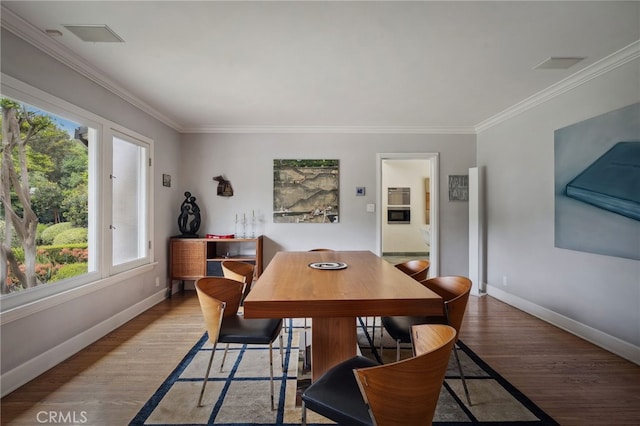 3818 Hollyline Ave, Sherman Oaks, CA 91423 - dining room featuring crown molding, baseboards, wood finished floors, and plenty of natural light