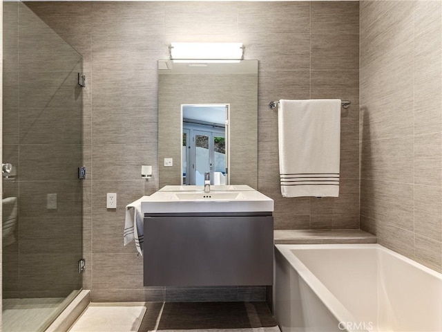 3818 Hollyline Ave, Sherman Oaks, CA 91423 - full bath with a stall shower, a bath, vanity, french doors, and tile walls