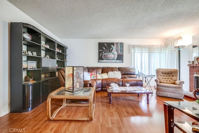 25681 Westover Cir, Lake Forest, CA 92630 - living area with a textured ceiling, light wood-type flooring, and a fireplace