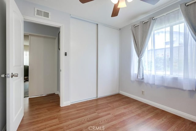 25681 Westover Cir, Lake Forest, CA 92630 - unfurnished bedroom with light wood-style floors, baseboards, multiple windows, and a closet
