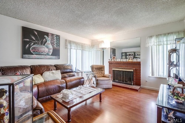25681 Westover Cir, Lake Forest, CA 92630 - living area featuring a textured ceiling, a fireplace, wood finished floors, and baseboards