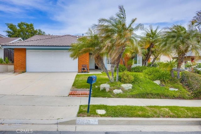 25681 Westover Cir, Lake Forest, CA 92630 - view of front of home featuring a garage, a tile roof, concrete driveway, brick siding, and a front lawn