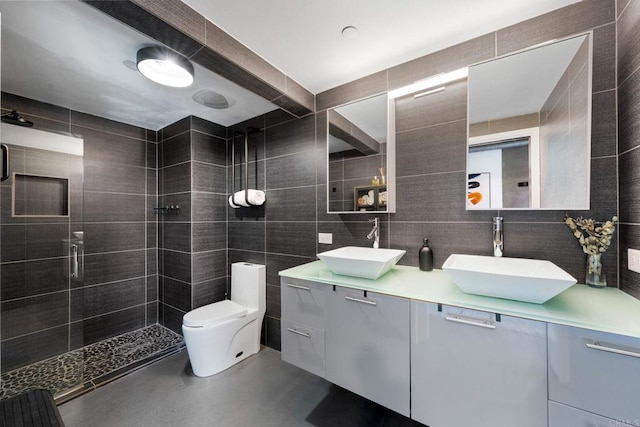 1080 Park Blvd Unit 701, San Diego, CA 92101 - full bathroom with tile walls, a shower stall, toilet, double vanity, and finished concrete flooring