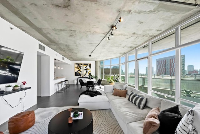1080 Park Blvd Unit 701, San Diego, CA 92101 - living area featuring a skyline view, a water view, rail lighting, wood finished floors, and floor to ceiling windows