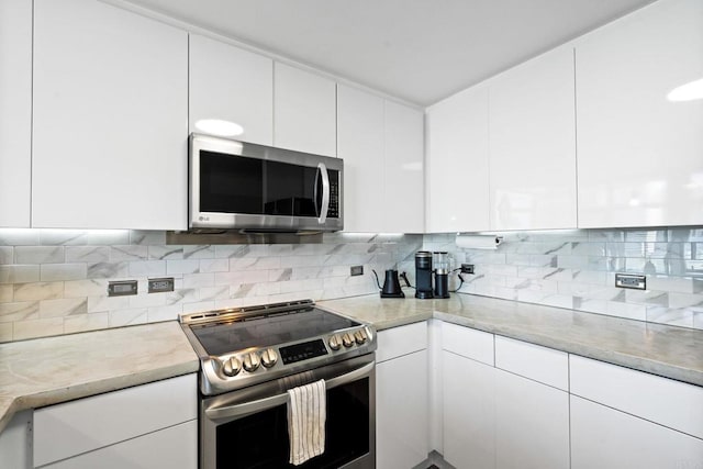 1080 Park Blvd Unit 701, San Diego, CA 92101 - kitchen featuring appliances with stainless steel finishes, white cabinetry, tasteful backsplash, and light countertops