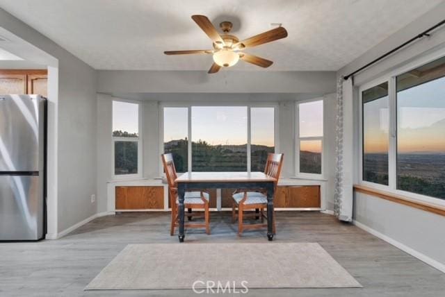 25624 Castlerock Rd, Apple Valley, CA 92308 - dining area featuring baseboards, plenty of natural light, and wood finished floors