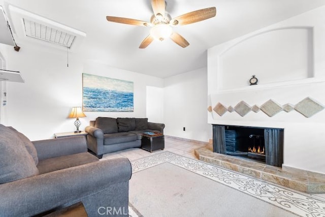 1800 E Heim Ave Unit 2, Orange, CA 92865 - living area featuring attic access, a ceiling fan, a warm lit fireplace, tile patterned flooring, and baseboards