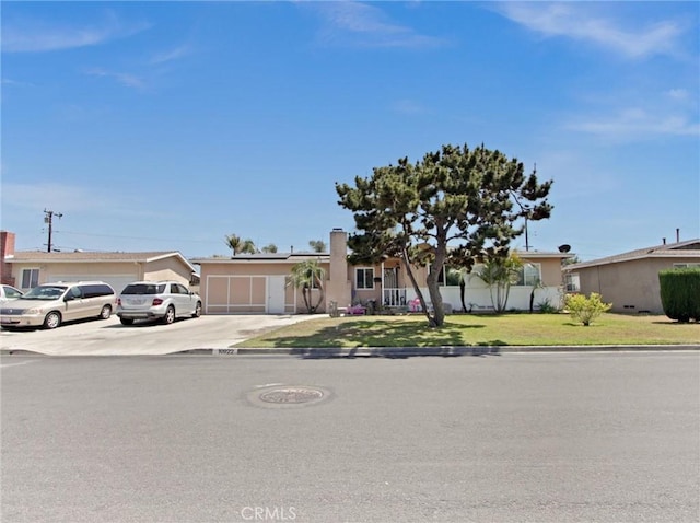 10922 Vickers Dr, Garden Grove, CA 92840 - single story home featuring concrete driveway, solar panels, a front yard, and an attached garage