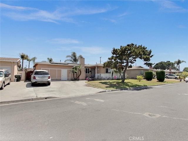 10922 Vickers Dr, Garden Grove, CA 92840 - ranch-style house with concrete driveway, solar panels, stucco siding, and a chimney