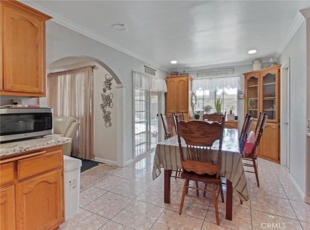 10922 Vickers Dr, Garden Grove, CA 92840 - dining room with crown molding, baseboards, arched walkways, light tile patterned flooring, and recessed lighting