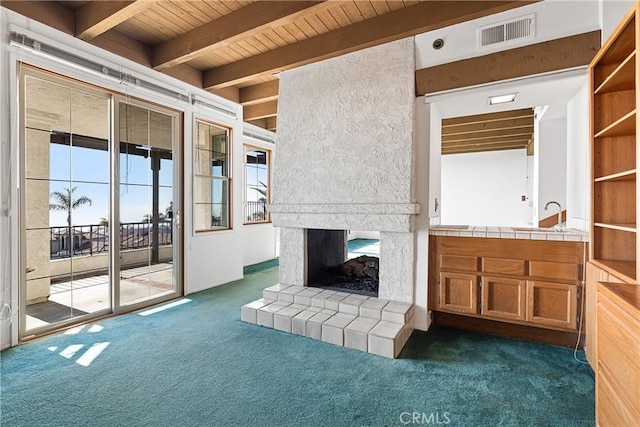 537 Avenida Buenos Aires, San Clemente, CA 92672 - unfurnished living room featuring dark colored carpet, beamed ceiling, wooden ceiling, and a multi sided fireplace