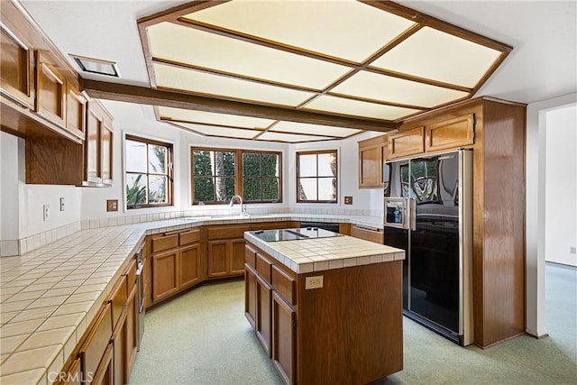537 Avenida Buenos Aires, San Clemente, CA 92672 - kitchen featuring tile countertops, black appliances, a kitchen island, and brown cabinets