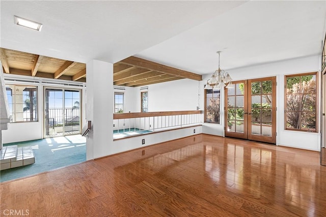 537 Avenida Buenos Aires, San Clemente, CA 92672 - unfurnished dining area featuring wood finished floors, beamed ceiling, a chandelier, and french doors