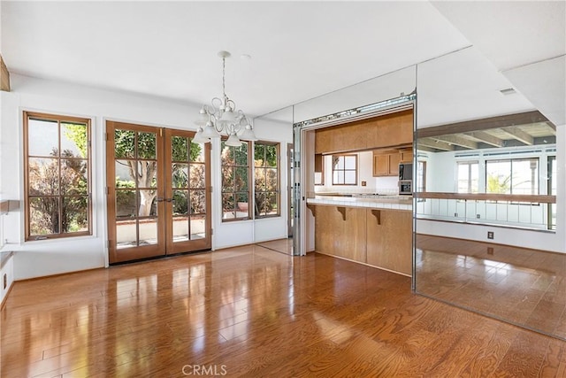 537 Avenida Buenos Aires, San Clemente, CA 92672 - kitchen with french doors, a chandelier, wood finished floors, and light countertops