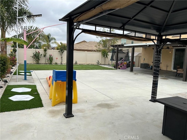 view of property's community with a fenced backyard, a gazebo, and a patio area