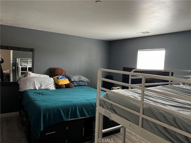 bedroom with wood finished floors