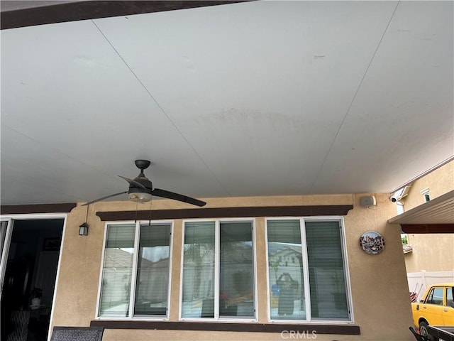 exterior view of ceiling fan and stucco siding