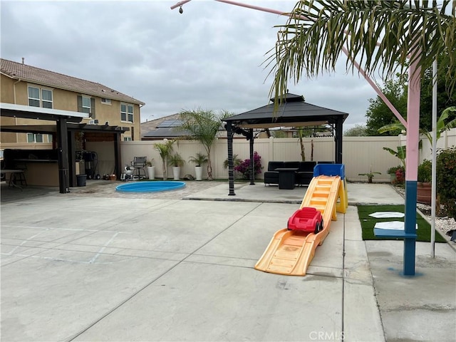 view of patio featuring outdoor lounge area, a gazebo, and a fenced backyard