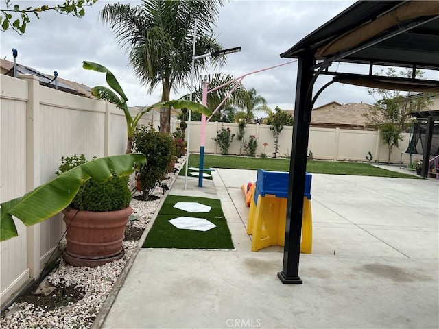 surrounding community with a fenced backyard, a patio area, and a gazebo