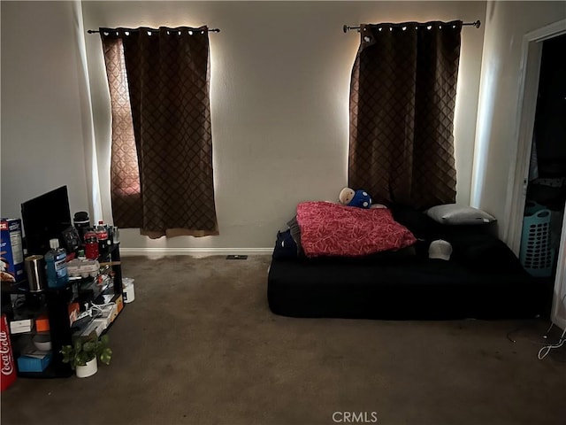 sitting room featuring carpet and baseboards