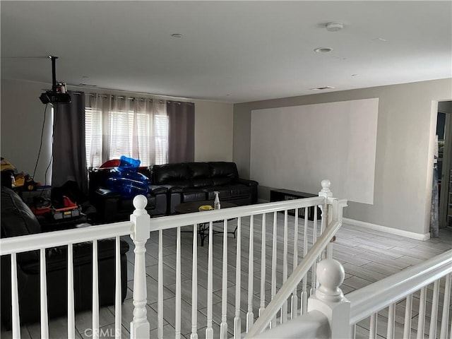 living area featuring baseboards and wood finished floors