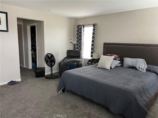 bedroom featuring carpet and baseboards