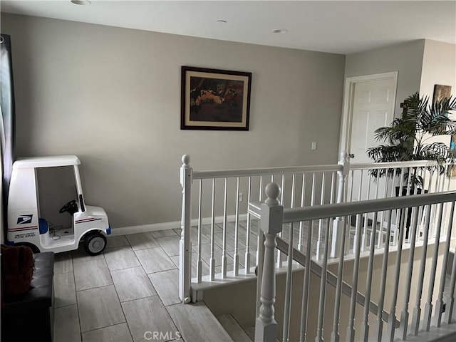 stairs featuring baseboards and recessed lighting
