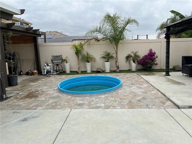 view of pool featuring a fenced backyard, a patio, and an in-ground hot tub