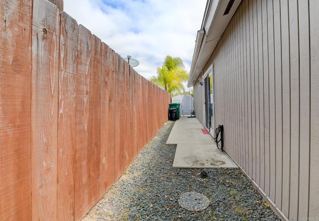 view of side of home featuring fence and a patio area