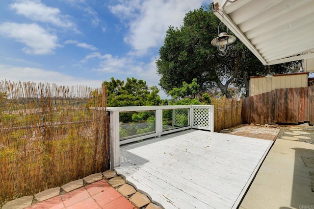 wooden terrace featuring fence