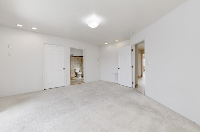 spare room featuring carpet and recessed lighting