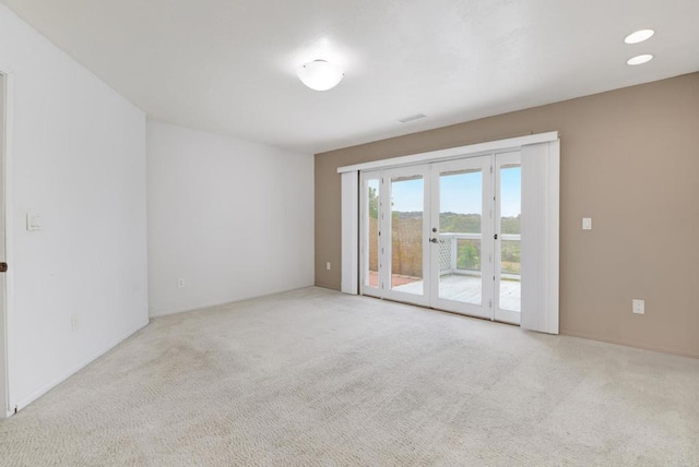 spare room with carpet floors and french doors